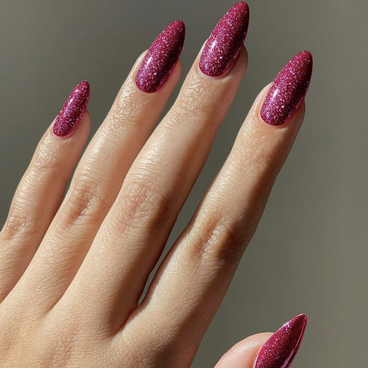 A set of long, almond-shaped, burgundy glitter finish press-on nails.