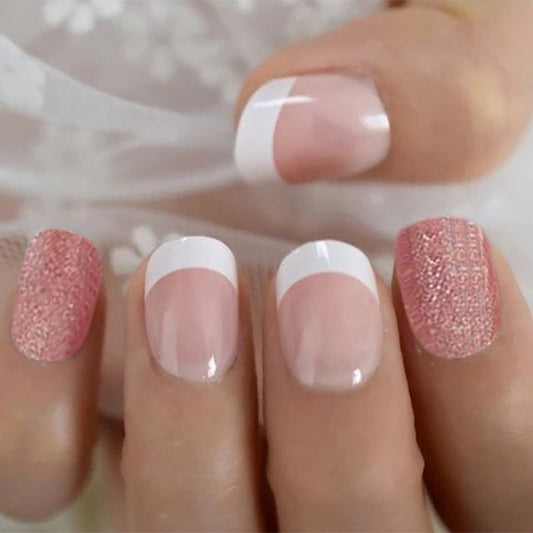 Close-up of a hand with pink and white nail polish
