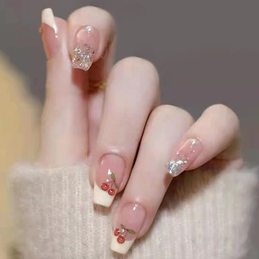 Winter Whimsy Long Coffin Translucent Press-on Nails with Cherry Blossom Accents and Glitter Highlights