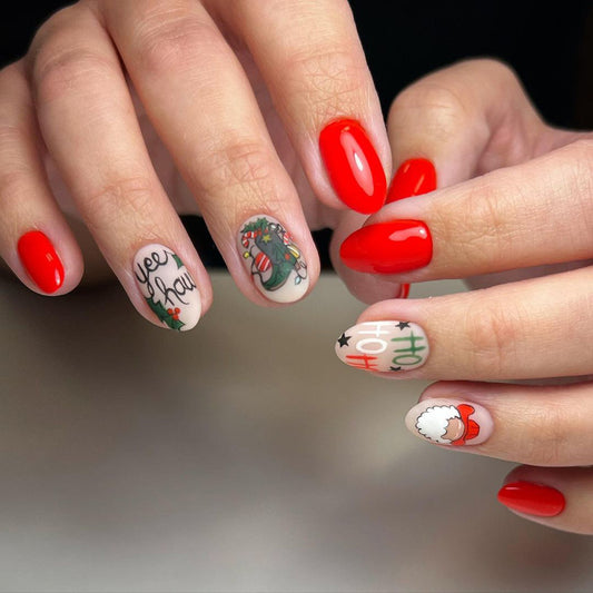 Close-up of hands with red nail polish and festive nail art on a neutral background