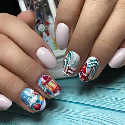 A person's hand with medium-length oval nails adorned with a multicolor winter landscape design, including elements like snowflakes and holiday decorations.