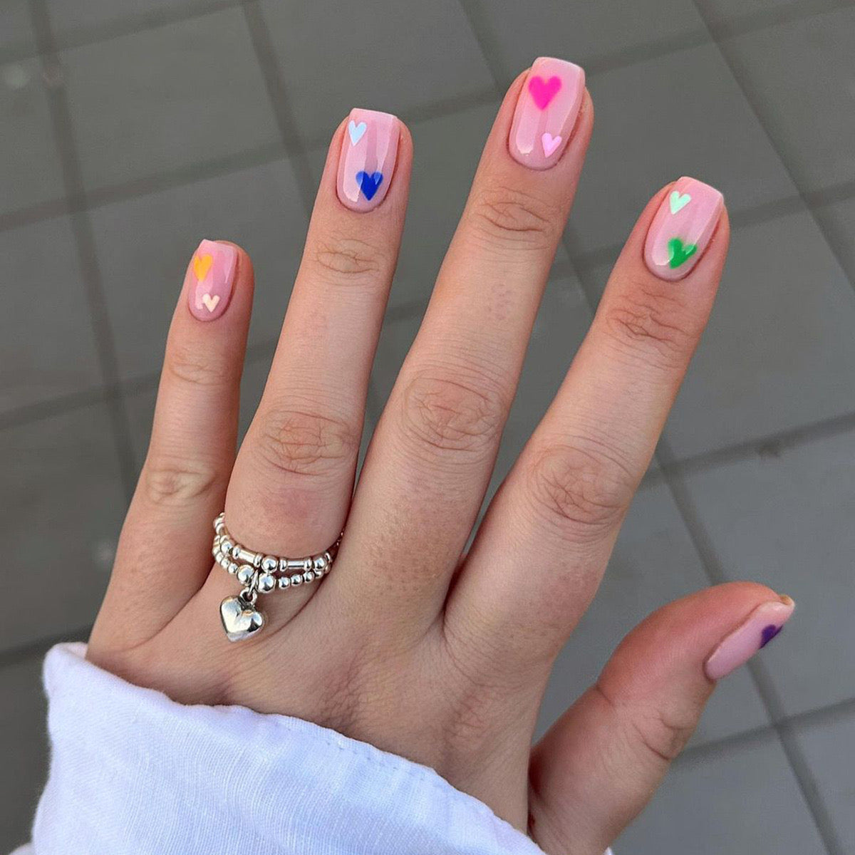Playful Pastel Short Square Press-On Nails with Multicolored Heart Accents for a Cheerful Touch