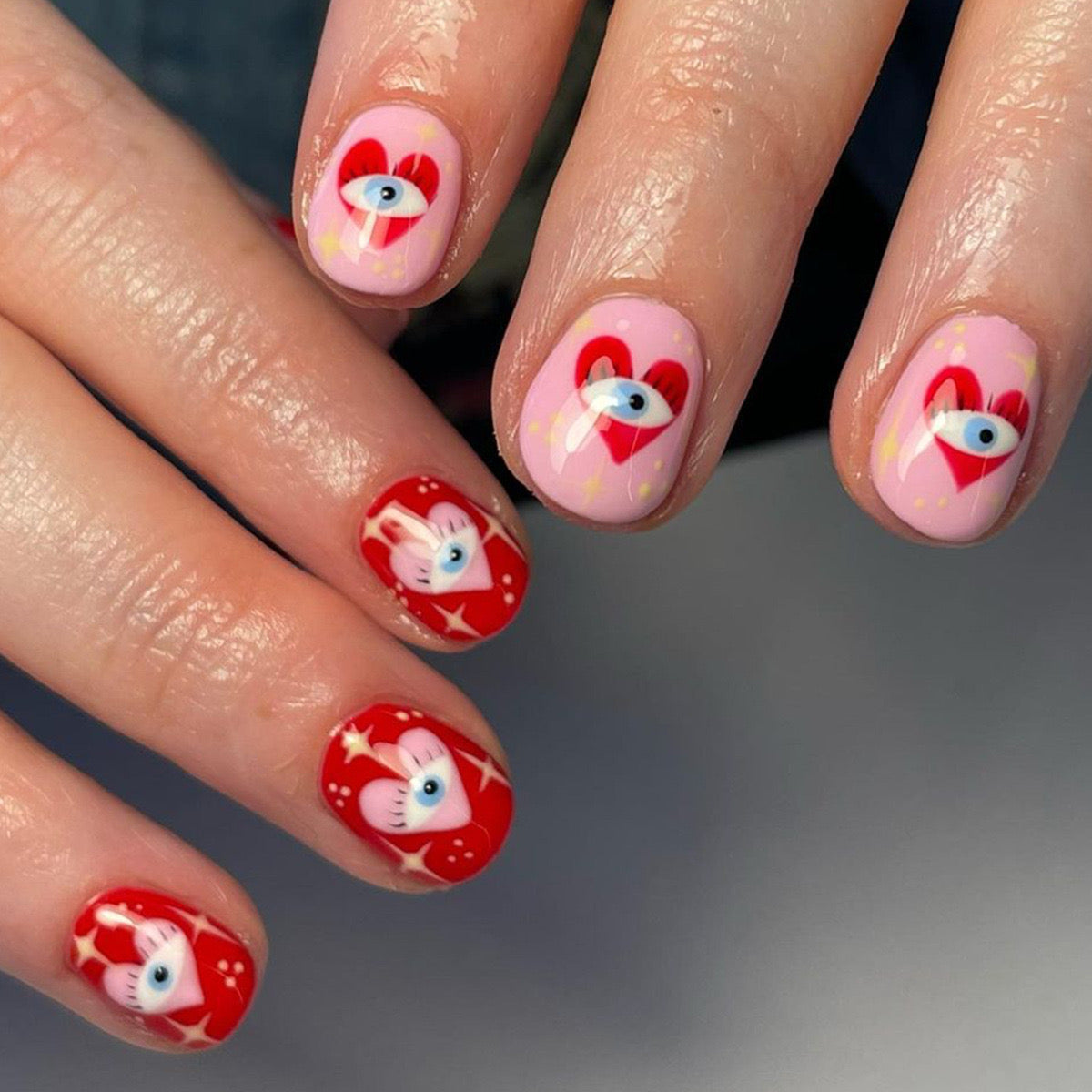 Enchanted Critters Short Oval Pastel Pink and Vibrant Red Press-On Nails with Playful Animal Designs