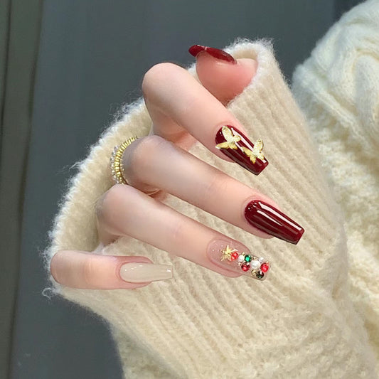 Holiday Glam Long Coffin Press-On Nails in Deep Red with Gold Bow Accent and Festive Rhinestone Embellishments