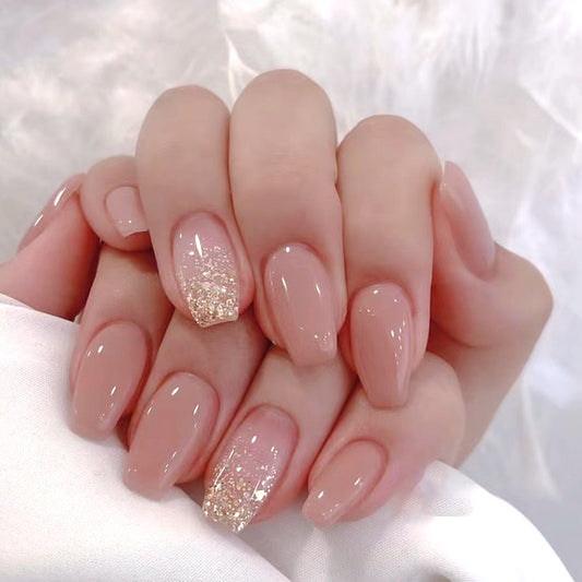 Hand with pink nails and glittery accents on a white background