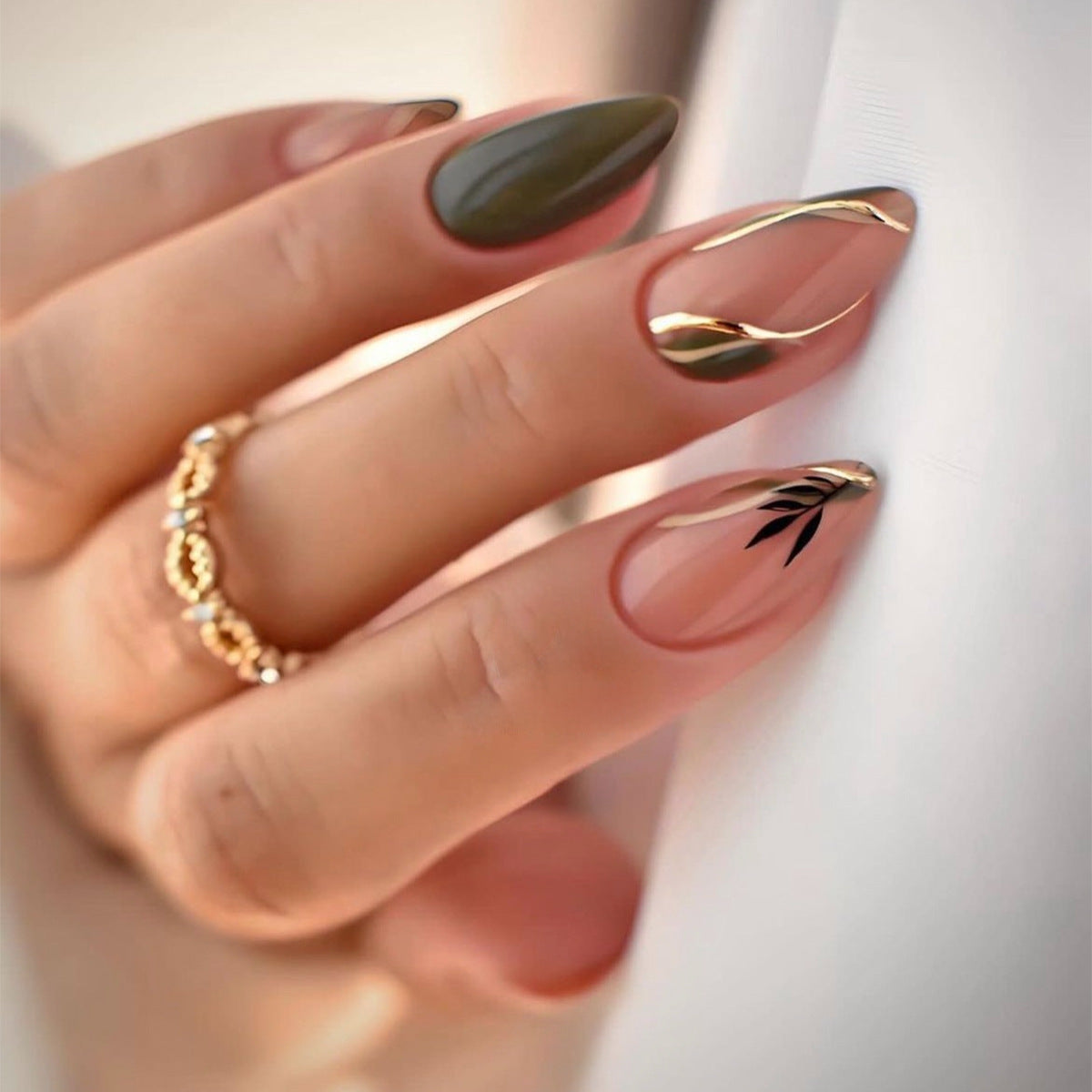 Sleek Medium Almond Olive and Beige Press-On Nails with Gold Accent Lines and Leaf Detail