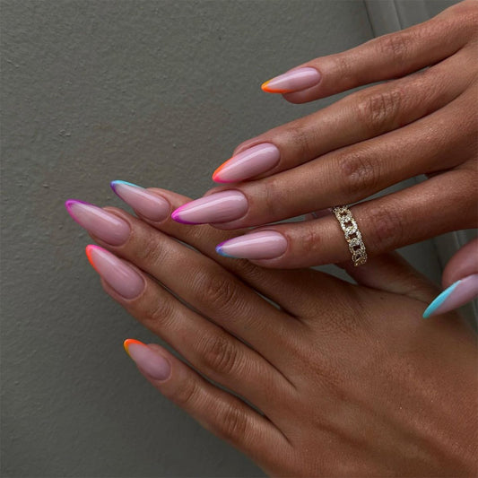 A set of long, almond-colored press-on nails with multicolored French tips.