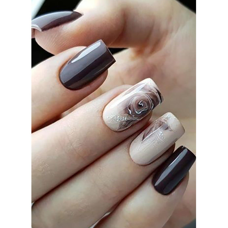 Close-up of a hand with marbled nail art on a white background