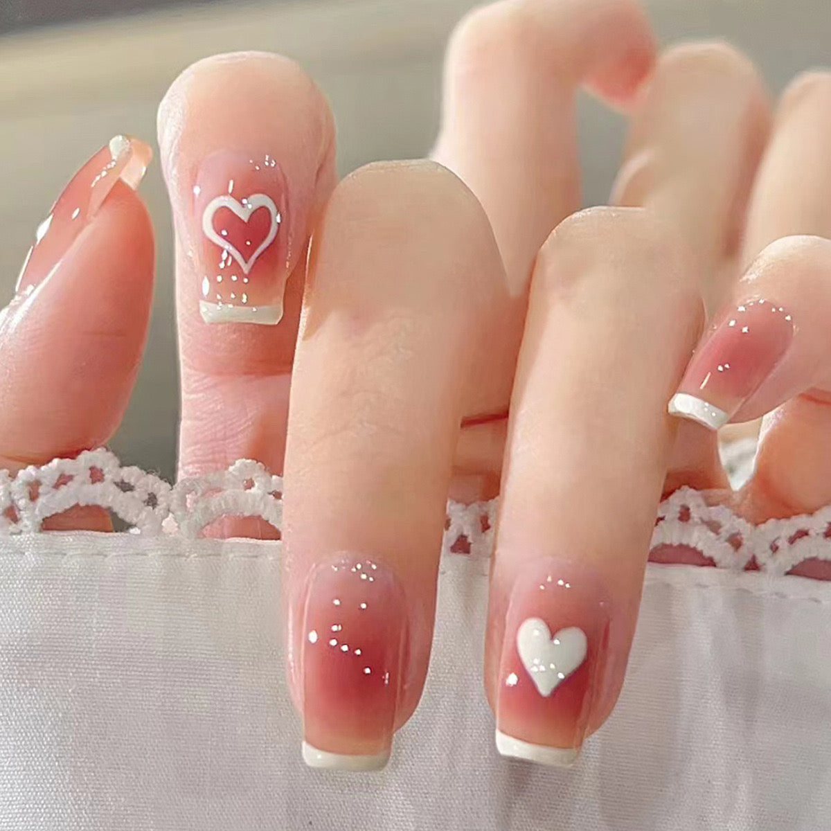 Sweetheart Blush Medium Coffin Ombre Press-On Nails with White Heart Accent and Glitter Detail