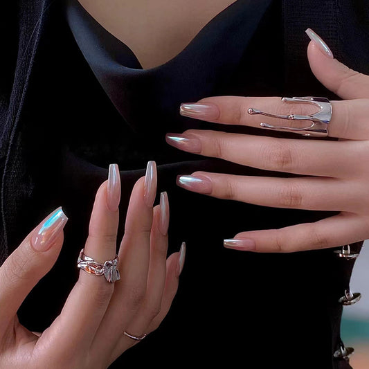 Close-up of hands with silver rings and manicured nails against a black background