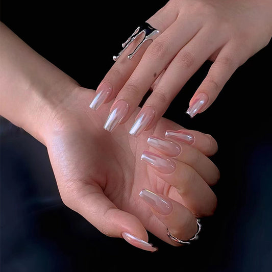 Close-up of two hands with clear nail polish on a dark background