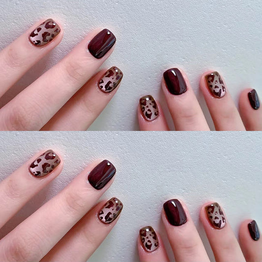 A set of brown false nails with leopard print accents, designed to be worn on short nails.