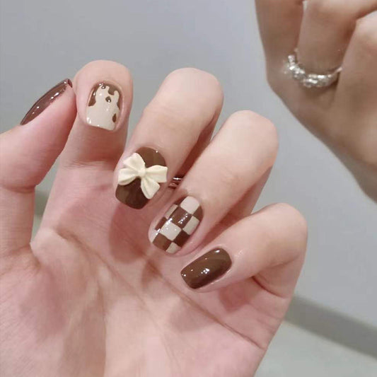 Sweet Mocha Short Squoval Press on Nail Set in Glossy Brown with Checkered Pattern and Bow Detail