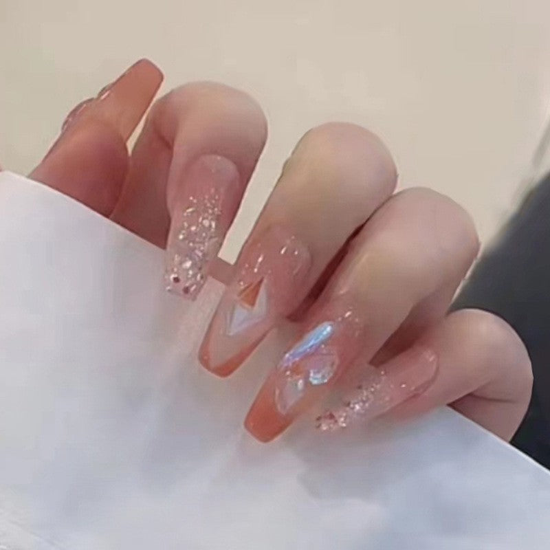 Cosmic Glow Medium Coffin Peach Press On Nails with Iridescent Triangle Accents and Glitter Detail