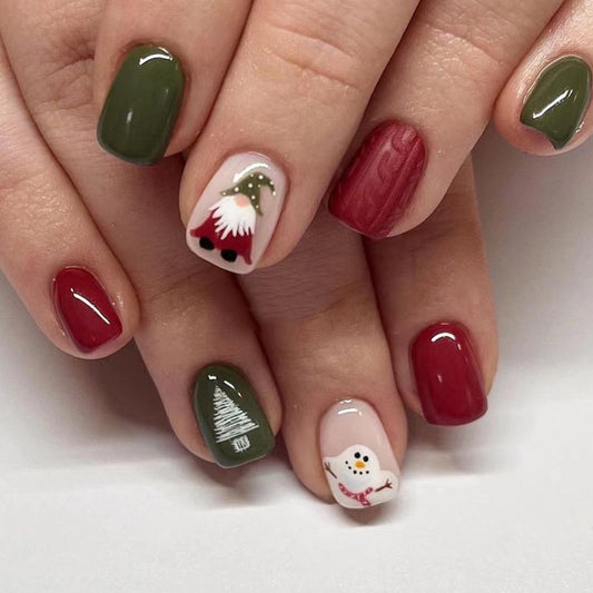 Nails with Christmas-themed designs on a white background