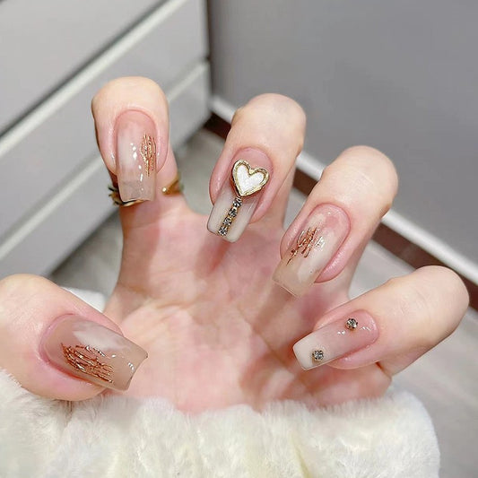 Golden Embrace Medium Square Sheer Pink Press On Nail Set with Gold Foil Wings and Heart Charm Accents