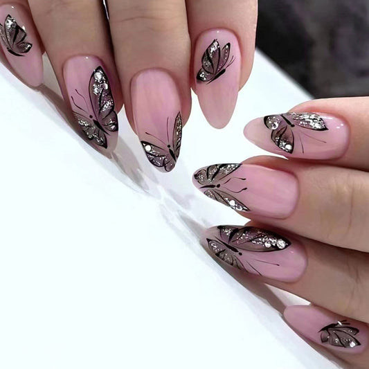 Nails with pink polish and butterfly designs on a white background