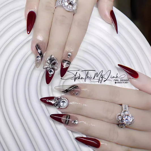 Glamour Night Extra Long Stiletto Burgundy Press On Nails with Silver Jewel Accents and Designer Brand Motifs